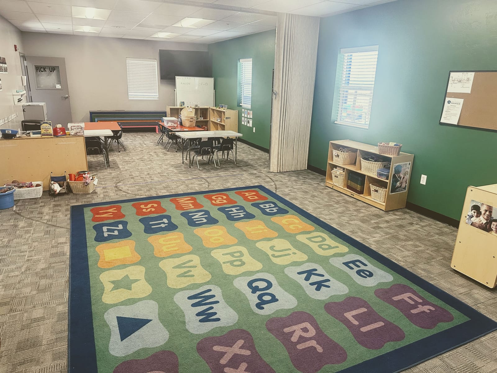 A bright Cactus Wren classroom with an alphabet learning rug